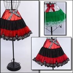 a red, green and black skirt on a mannequin with ribbon around the waist