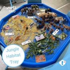 a blue table topped with lots of different types of toy figurines and toys