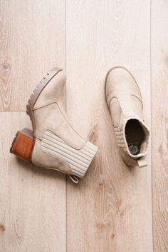 The Taiya Boot offers a chic, modern take on the classic Chelsea boot. Crafted from a soft taupe suede-like material, these boots feature elastic ribbed side panels for a comfortable and flexible fit. The sturdy wooden block heel adds height without sacrificing stability, while the treaded sole provides extra grip. Perfect for transitioning between seasons, and pairs effortlessly with everything from jeans to dresses, making it a must-have for the modern woman on the go.

2.25" Heel height
0.75" Platform height
1.5" Footbed height
Faux Leather / Textile Upper
Rubber outsole Short Leggings, Skirt Leggings, Brown Boots, Shoe Sale, Long Tops