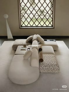 a large white couch sitting in front of a window