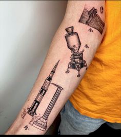 a man with a tattoo on his arm that has an image of a rocket ship