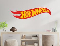 a wall decal with the word'hot wheels'in red and yellow on it