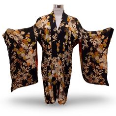 Embrace the beauty of Japanese culture with this stunning black and beig, 1940s,  floral print kimono. The garment boasts 3/4 kimono sleeves and inside ties for closure, making this a perfect casual wear for any occasion. The relaxed fit and rayon material ensure comfort while maintaining a stylish look. This kimono is a one-size-fits-all S, making it a must-have addition to any wardrobe. The topper has been carefully crafted to meet the highest standards, making it ideal for anyone who wants to Traditional Black Floral Print Kimono, Floral Print Kimono For Tea Ceremony, Traditional Black Kimono With Floral Print, Vintage Kimono With Kimono Sleeves, Vintage Black Kimono For Spring, Black Bohemian Kimono With Floral Print, Vintage Long Floral Print Kimono, Bohemian Maternity, Floral Print Kimono