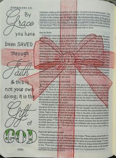 an open bible with a red ribbon on it