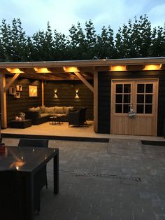 an outdoor living area is lit up at night