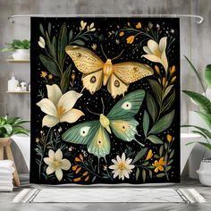 a shower curtain with two butterflies and flowers on it, in front of a bathtub