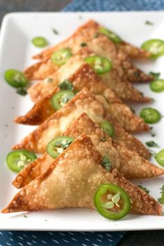 some food is on a white plate with green peppers and jalapeno slices