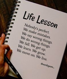 a person writing on a notebook with a pen in their hand and the words life lesson written above it