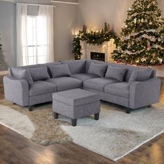 a living room filled with furniture and a christmas tree