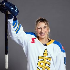 a female hockey player is posing for a photo