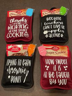 three bags of cookies with sayings on them sitting on the floor next to each other