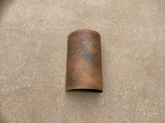 a metal tube laying on the ground with no one around it or someone else is looking at it