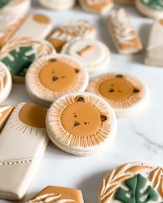 several decorated cookies with lions on them sitting on a white counter top next to each other