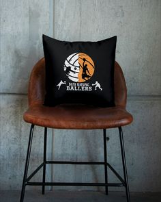 a pillow sitting on top of a chair in front of a wall with an image of a basketball player