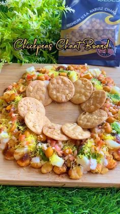 a close up of a plate of food with crackers and vegetables in the middle