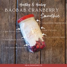 a mason jar filled with cranberry smoothie ingredients on top of a wooden table