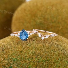 a close up view of a ring with a blue stone on the front and side