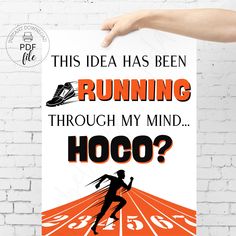 a person holding up a poster with the words running through my mind hoco?