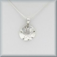 "This necklace features a beautifully detailed sand dollar pendant. Highly polished and absolutely lovely - the perfect necklace for summer! Pendant is a bit more than 1/2\" long (16 mm). All components, including box chain, are sterling silver. Coordinating earrings can be found here: https://www.etsy.com/listing/277982012/sand-dollar-earrings-sterling-silver?ref=shop_home_active_68 Jewelry is packaged in a cotton lined box for gift-giving. See more Bonny Jewelry at http://bonnyjewelry.etsy.com Silver Round Beach Necklace, Silver Necklace For Beach, Sterling Silver Pendant Necklace For Beach, Silver Pendant Necklaces For Vacation, Silver Pendant Necklace For Vacation, Sand Dollar Earrings, Sand Dollar Necklace, Sand Dollar Pendant, Ocean Necklace