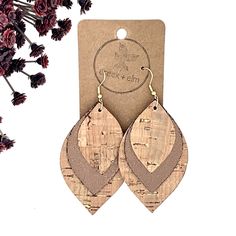 the earrings are made out of wood and have leather details