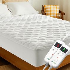 an electric mattress is hooked up to the bed with two remote controls on each side