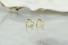 14k gold heart earrings, made with a delicate design and size. The smooth surface and lines give you a jewelry piece that will complete your outfit for work, leisure, or even special occasions. 💎Design: Delicate open heart earrings 💎Material: 14k solid gold and and a layer of E-Coating that acts as protection against tarnish and scratches ,which will keep your earring looking spotless 💎Earrings size: 6.2mm x 6.5mm The earrings come in a charming jewelry box. Additionally, you will also get a Delicate Gold Heart Earrings For Anniversary, Dainty Open Heart Earrings For Anniversary, Gold Open Heart Earrings For Anniversary, 14k Gold Open Heart Earrings Gift, Yellow Gold Open Heart Earrings For Anniversary, Hypoallergenic Open Heart Earrings For Anniversary, Delicate Heart Earrings For Valentine's Day, Anniversary Heart Earrings, Yellow Gold Pierced Open Heart Earrings