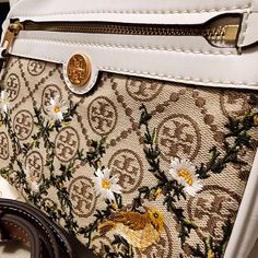 Nwt ~ Very Rare~Tory Burch T Monogram Jacquard Embroidered Crossbody Camera Bag. Extremely Hard To Find! & Sold Out Everywhere!! This Exquisite Authentic Tory Burch Jacquard In The T Monogram Classic Pattern That Boasts Ecru Stitching, Embroidered Climbing Vines, Daisies, And Goldfinches Each Trimmed With Genuine Refined Leather, Is A Jaw Dropping Must Have! The Camera Bag Has A Top Handle And An Adjustable Crossbody Leather Strap Measuring A 22.5" Drop. Gold Hardware Brand Logo Emblem And Zip C Designer White Embroidered Bag, Designer White Bag With Embroidered Logo, Designer Embroidered Shoulder Bag For Travel, Luxury Embroidered Cream Bag, Crossbody Camera Bag, Tory Burch Kira Chevron, T Monogram, Kira Chevron, Tory Burch Purse