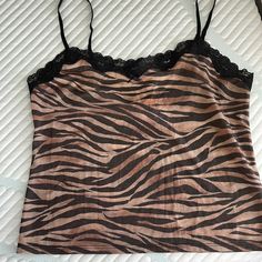 Victoria’s Secret Zebra Print Shimmer Camisole/Tank Top. Size L. Nwt. Has Shimmer Effect All Over. Lace Trim Around The Top Of The Front And Back With A Little Bow In The Middle Of The Front. Adjustable Straps. Perfect Condition. No Pulls, No Tears! Y2k Cami Tank Top With Built-in Bra, Y2k Style Camisole With Tank Straps, Y2k Tank Camisole With Built-in Bra, Y2k Camisole With Built-in Bra, Y2k Tank Top With Straps, Y2k Style Tank Top With Straps, Trendy Camisole Tank Top For Loungewear, Y2k Sleeveless Top With Lace Trim, Lace Trim Tank Top For Loungewear