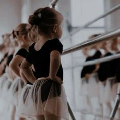 young ballerinas in black and white tutus lined up at the ballet school