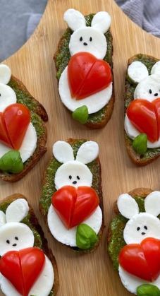 toasted sandwiches with white and red toppings are arranged on a wooden platter