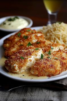 some food is on a white plate with gravy and mashed potatoes next to it