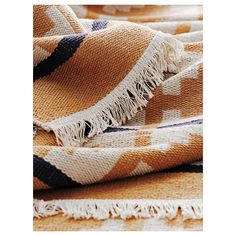 an orange and black checkered blanket with fringes