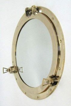 a mirror that is on the wall with some metal parts in front of it,