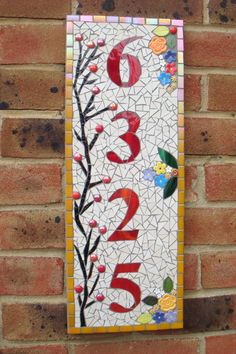 * 4 Digit Vertical orientation mosaic house number made to order. This one measured 20" x 7 1/2 ".  Made on Corian base with frost and UV safe stained glass and ceramic materials. 2 keyhole hangers on reverse. Please contact me to discuss your custom request with no obligation. Corian® is:  Stain resistant  Durable: Tough and long-lasting  Can be renewed: Colour runs all the way through, making restoration easy if necessary An excellent choice for exterior applications Heat-resistant  Easy-to-cl Mozaik Art, Outdoor Wall Hanging, House Numbers Diy, Address Signs, Mosaic Art Projects, Mosaic Stained, Mosaic Madness, Door Number, Mosaic Pictures