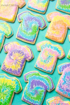 tie - dyed cookies are arranged on a blue tablecloth with green and yellow colors