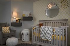 a baby's room with gray and yellow decor