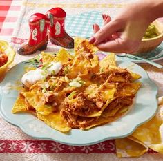 a plate with nachos and salsa on it