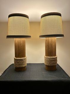 two lamps made out of wood and rope