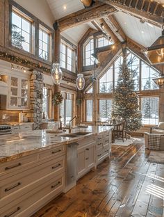 a large kitchen with wooden floors and white cabinets is decorated for the christmas holiday season