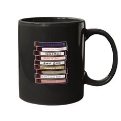 a black coffee mug filled with lots of different types of books on the inside of it