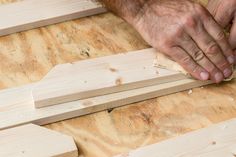 a man sanding wood on top of a wooden floor