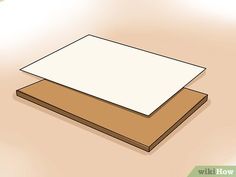 a piece of paper sitting on top of a wooden table next to a white board