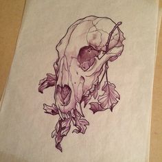 a drawing of a skull and flowers on a piece of white paper with purple ink