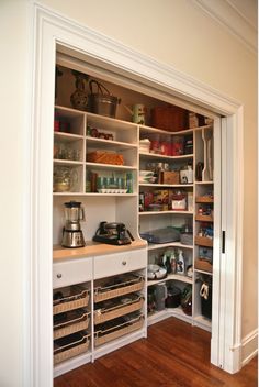 an open pantry with lots of items on the shelves and in front of it is a phone