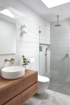 a bathroom with a sink, toilet and shower stall in it's own area