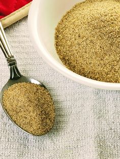 a white bowl filled with brown sugar next to a spoon