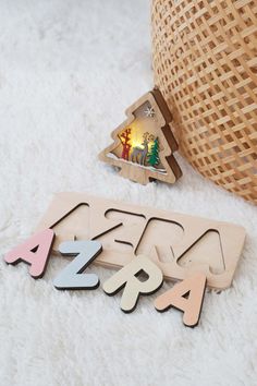 wooden christmas tree cutouts on white carpet next to basket