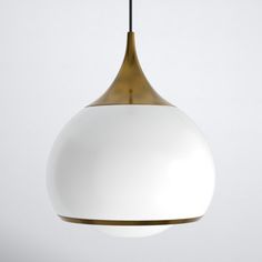 a white and gold pendant light hanging from a ceiling