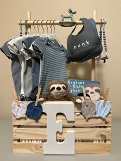 a wooden crate filled with baby clothes and toys