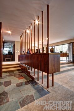 an empty room with wooden columns and tiled flooring